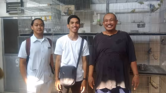 A happy family with the parrot they took home from Mysher Aviary