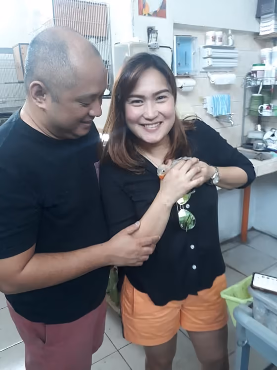 A happy family with the parrot they took home from Mysher Aviary