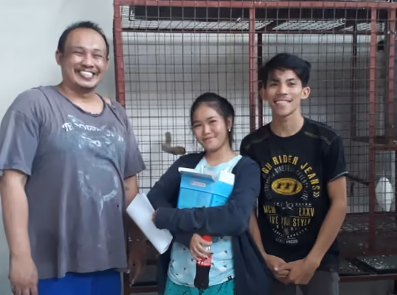 A happy family with the parrot they took home from Mysher Aviary