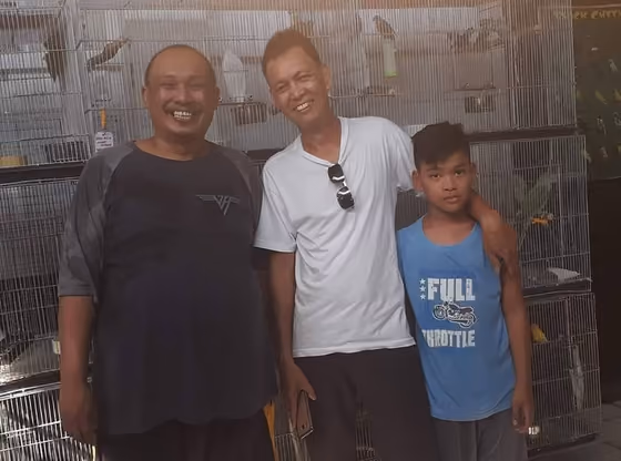 A happy family with the parrot they took home from Mysher Aviary