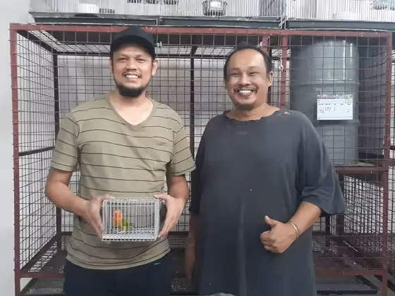 A happy family with the parrot they took home from Mysher Aviary