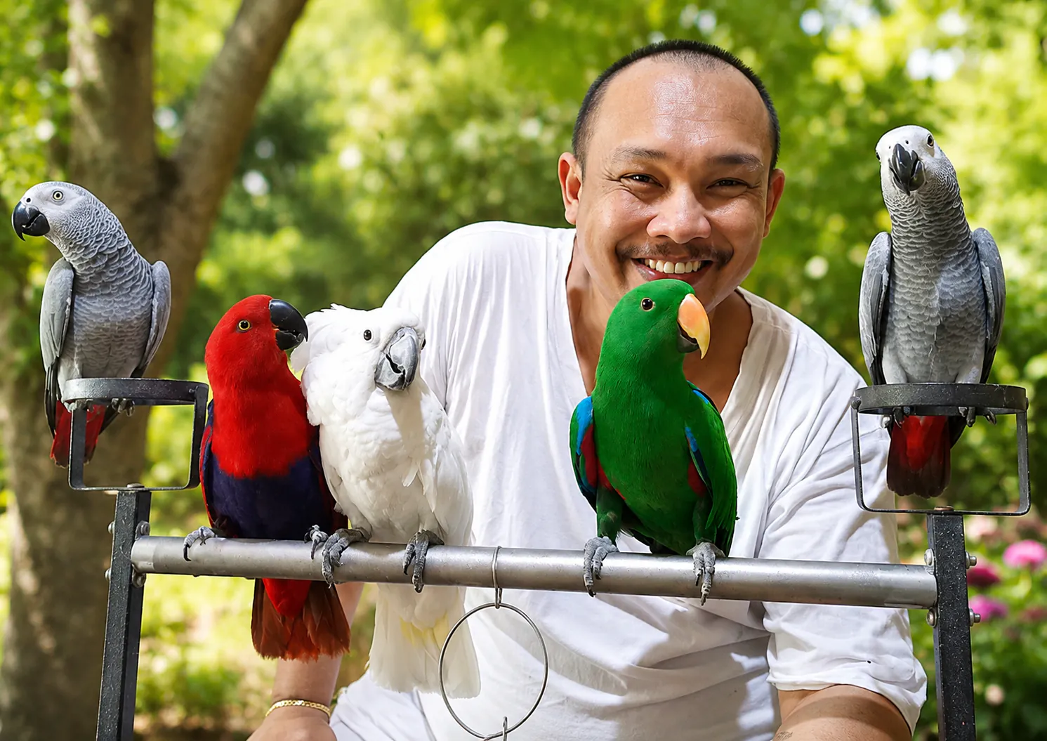 Sherwin with a handful of the aviary's parrots